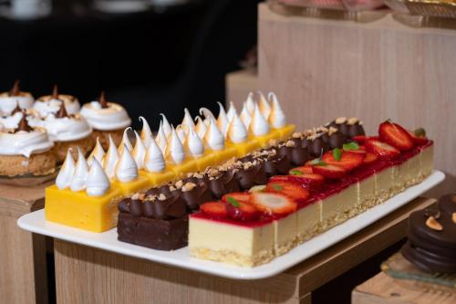 a plate of desserts on a table with strawberries and chocolate at Cala di Volpe Boutique Hotel in Montevideo