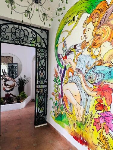 a mural on the wall of a room with a doorway at The Quetzal in Cancún