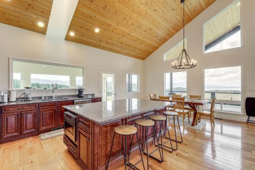 a kitchen with a large island with bar stools at Mountain and Lake View Rexford Estate on 28 Acres! in Rexford
