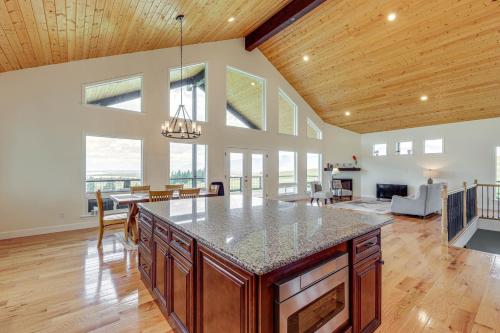 a kitchen with a large island in a living room at Mountain and Lake View Rexford Estate on 28 Acres! in Rexford