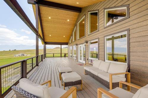a screened porch of a house with white furniture at Mountain and Lake View Rexford Estate on 28 Acres! in Rexford