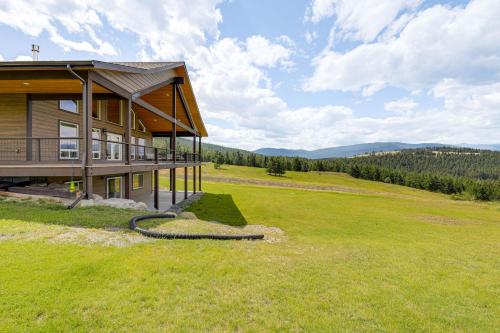a house on a hill with a large grass field at Mountain and Lake View Rexford Estate on 28 Acres! in Rexford