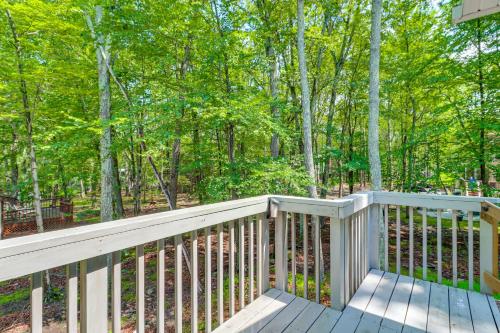 a wooden deck with a view of the woods at 7 Mi to Camelback Mtn Chic Penn Estates Home in East Stroudsburg