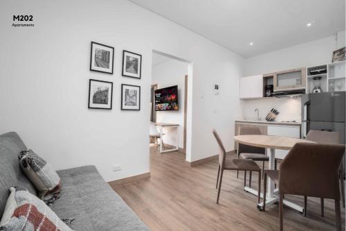 a living room with a couch and a table with chairs at Magusan Holiday Rentals in Cali