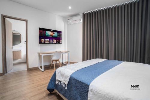 a hotel room with a bed and a table at Magusan Holiday Rentals in Cali