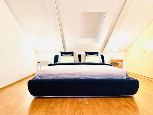 a bedroom with a large bed in an attic at ComeCasa No ZTL Alfieri Urban Stay in Asti