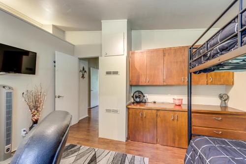 a bedroom with a bunk bed and a kitchen at Walk to Lake Fayetteville Family Retreat with Deck in Springdale