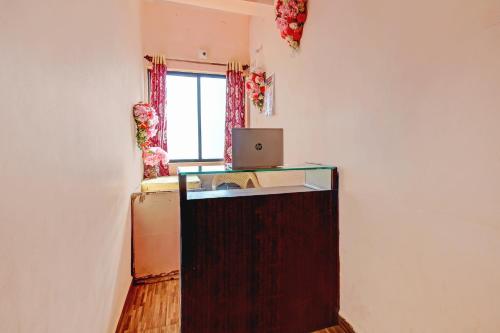 a room with a desk with a laptop on it at SPOT ON Shreekrupa in Mahabaleshwar