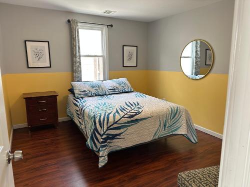 a bedroom with a bed and a mirror at JD Apartment and House in Seaside Heights