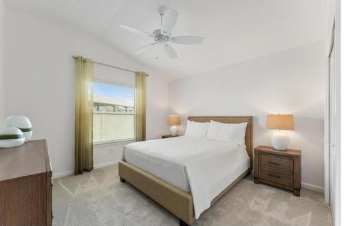 a white bedroom with a bed and a window at Designers 3BR in The Villages With Four Seaters Golfcart King Bed in The Villages