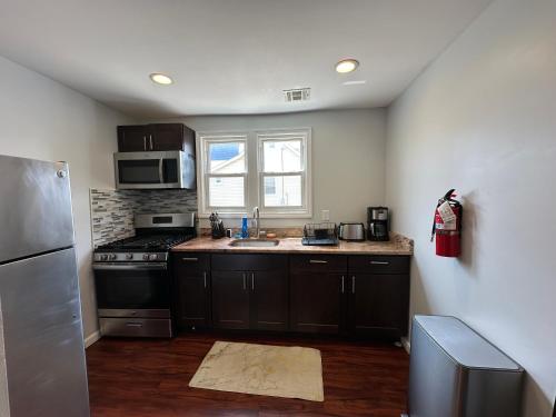 a kitchen with a sink and a stove top oven at JD Apartment and House in Seaside Heights