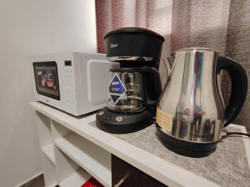 Una cafetera y un microondas en un mostrador en Plaza Chicama, en Puerto Chicama