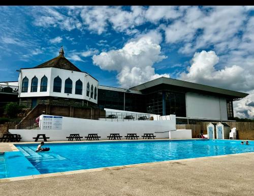 a swimming pool in front of a building at Hoburne Devon Bay Holiday Home Fresh Bright Rental - Home from home in Torquay