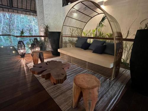 a living room with a rattan couch and a table at Hotel Mundo Maya Calakmul in Xpujil