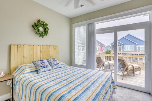 a bedroom with a bed and a sliding glass door at Surf City Home with Outdoor Shower Walk to Beach! in Surf City