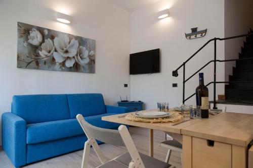 a living room with a blue couch and a table at Cinema Suite in Santa Margherita Ligure