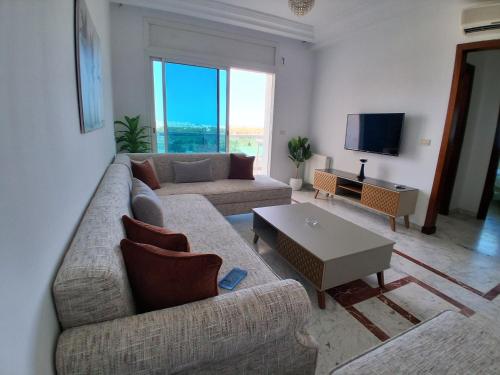 a living room with two couches and a tv at Luxury 1 bedroom apartment Lac 2 in El Aouina Station