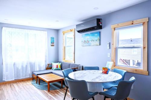 a living room with a table and chairs at Sea & Sun Cottage #3 in Hampton