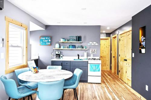 a kitchen with a table and chairs and a sink at Sea & Sun Cottage #3 in Hampton