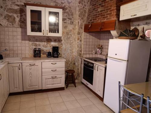 a kitchen with white appliances and a white refrigerator at Rethymno Rustic Serenity in Rethymno Town