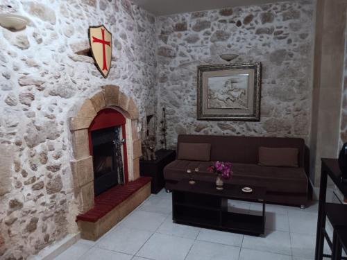 a living room with a couch and a fireplace at Rethymno Rustic Serenity in Rethymno Town