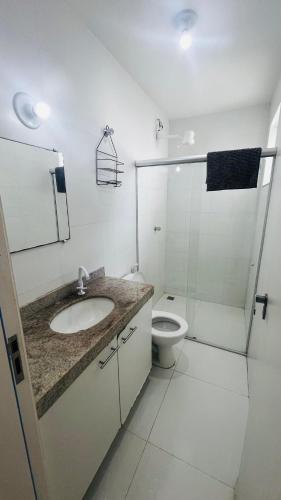 a bathroom with a sink and a toilet and a shower at Bahia Bella Casa 01 in Santa Cruz Cabrália