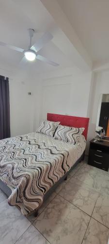 una cama en una habitación con ventilador de techo en Centro, en Paraná