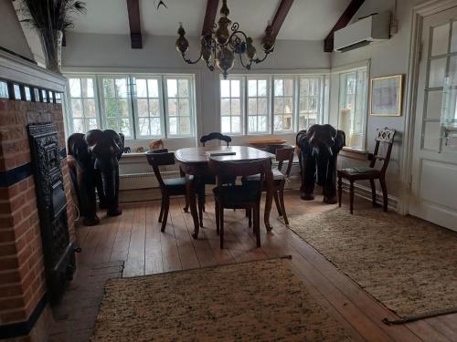 a dining room with a table and chairs and elephants at Jesters Island in Farum