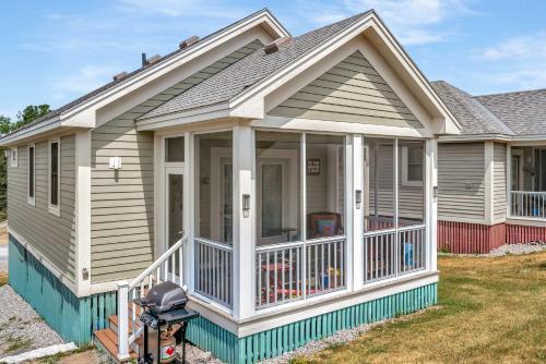 a screened in porch on a house with a grill at The Catbird - 28 Butternut in Cherry Valley