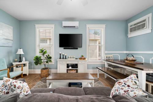 a living room with a couch and a tv at The Catbird - 28 Butternut in Cherry Valley