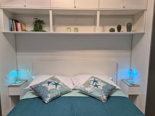 a bedroom with a bed with two pillows on it at Orchidea Bianca in Giardini Naxos