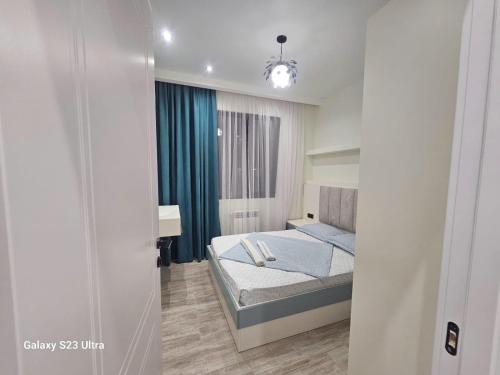 a small bedroom with a bed in a room at Apartment, premium class, near the sea 1718 batumi in Batumi