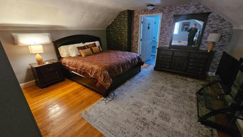 a bedroom with a bed and a dresser and a mirror at Urban Farmer House in Millman
