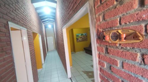 an empty hallway with a red brick wall and a room at Departamento Total en Santa Cruz - A in Santa Cruz de la Sierra