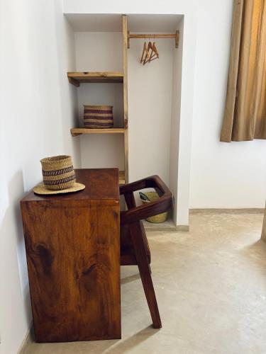 a hat sitting on a wooden desk in a room at Tumbili Hotel Boutique in Paje
