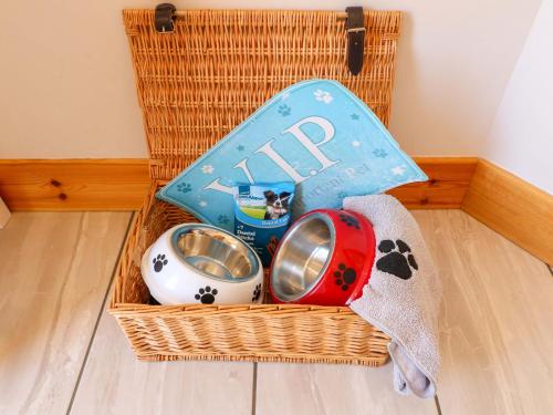 a basket with a dog toy and a playmat at Teal Cottage in Melton Mowbray