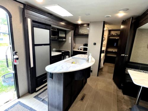 a bathroom with a sink in a rv at The Kodiak-Walk to Oaklawn & Bathhouses Downtown Hot Springs in Hot Springs