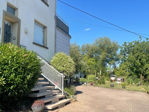 a house with a staircase next to a house at Haus Weiherfeld in Tholey