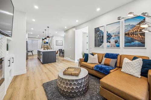 a living room with a couch and a table at Ultimate Group Stay, 3 King Beds, 2 Suites in Calgary