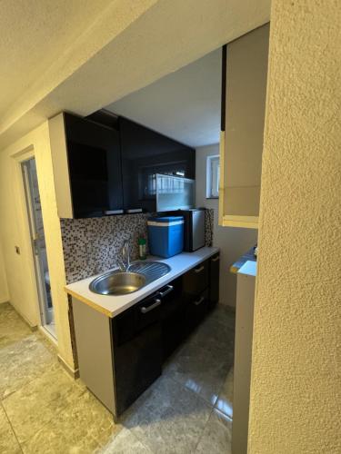 a kitchen with a sink and a counter top at Dardania Hostel in Peje