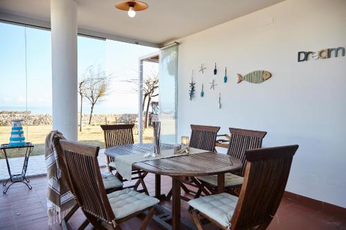 a dining room with a table and chairs at VILLA BY THE SEA - Accesso Privato al Mare in Polignano a Mare