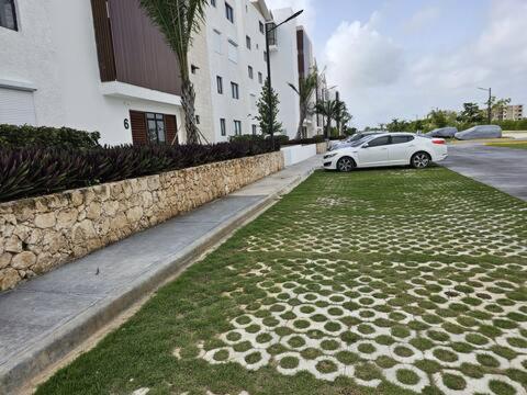 a white car parked on the side of a street at SantoriniRD in Punta Cana