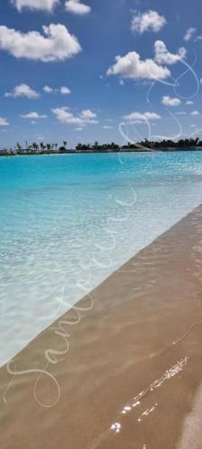 a view of the beach with a message in the sand at SantoriniRD in Punta Cana