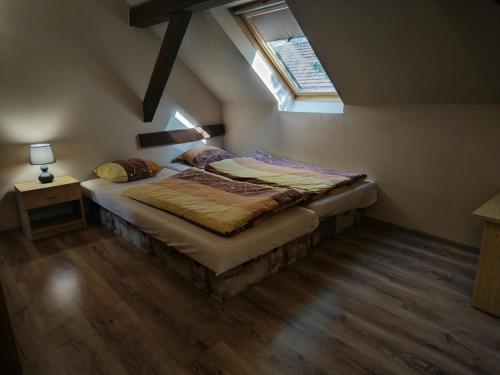 a bedroom with a large bed with a window at Mendi in Štúrovo