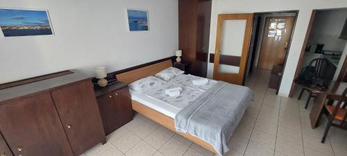 a small bedroom with a bed in a room at Apartment Sansimon in Izola