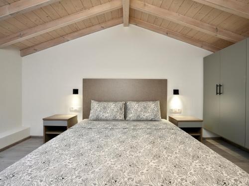 a bedroom with a large bed with two night stands at Anna's Corfu Escape Apartments 2 in Corfu