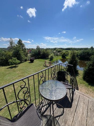 a table and chairs on a balcony with a view at Cisarska sadyba in Svityazʼ