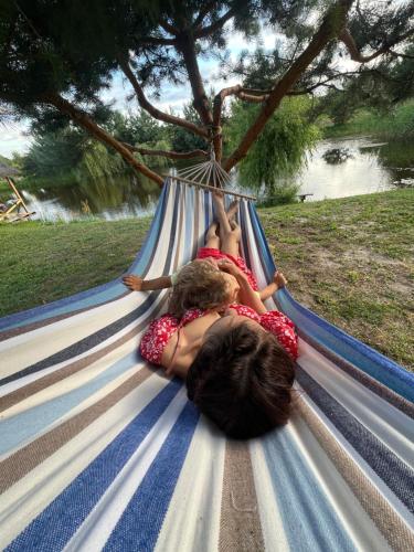 two children laying on a hammock at Cisarska sadyba in Svityazʼ