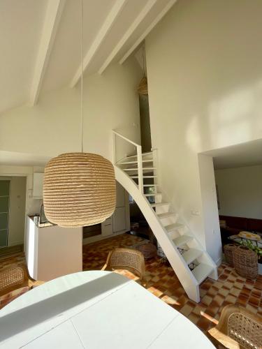 a living room with a staircase and a chandelier at Holiday home close to beach and Keukenhof in Noordwijkerhout