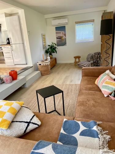 a living room with a couch and a table at Holiday home close to beach and Keukenhof in Noordwijkerhout